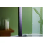 Avocado Gloss Cladding installed in a bathroom showing a still wet shower screen and reflection of shower head in the cladding.