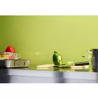 Cladding installed above a stainless steel kitchen worktop. The surface is holding a chopping board, pans, utensils, and various colourful peppers.