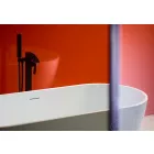 Orange Gloss Cladding installed in Bathroom with white bath, black tap unit and shower screen.