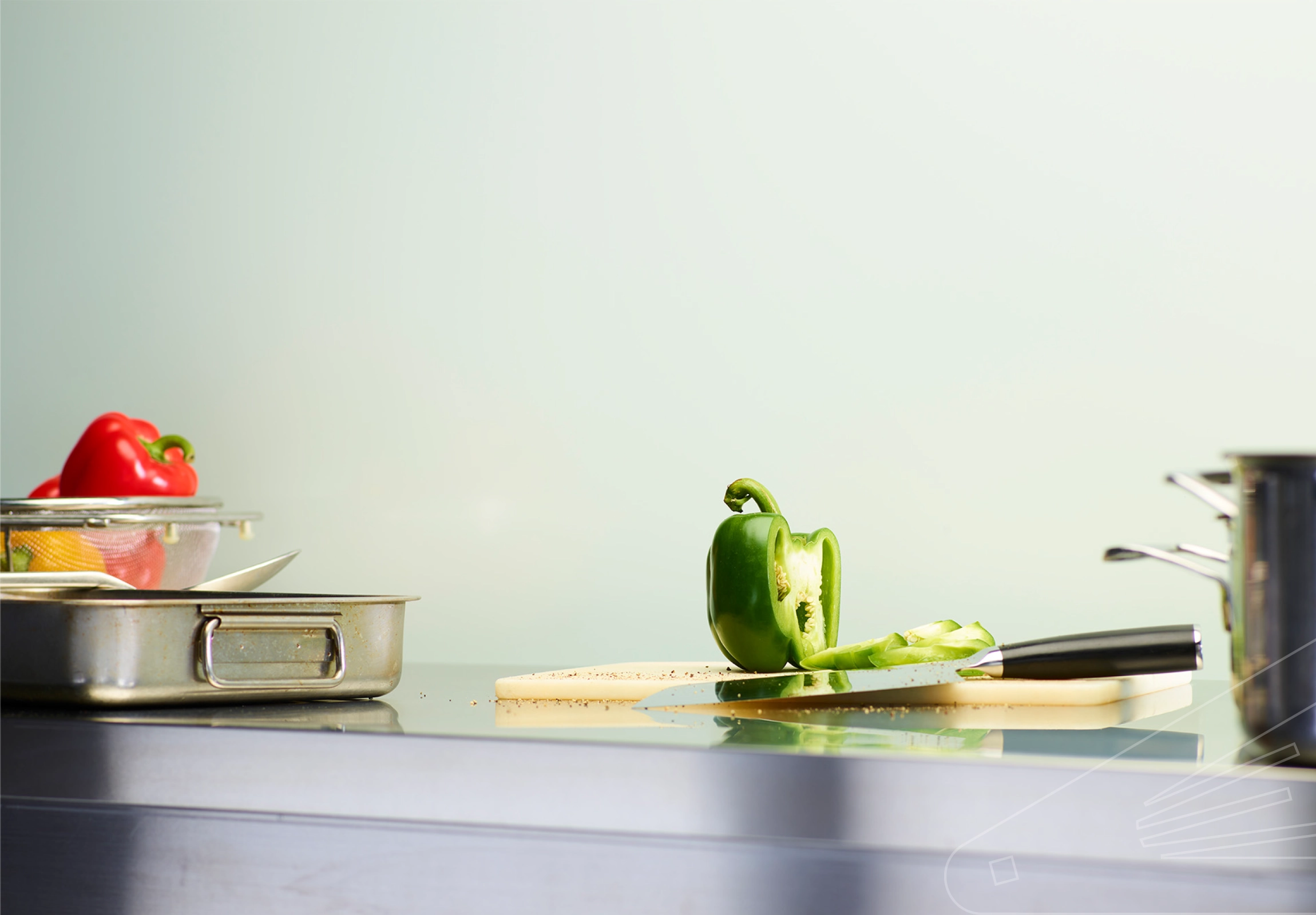 Duck Egg Satin Cladding installed in kitchen with steel work top and chef's paraphernalia.
