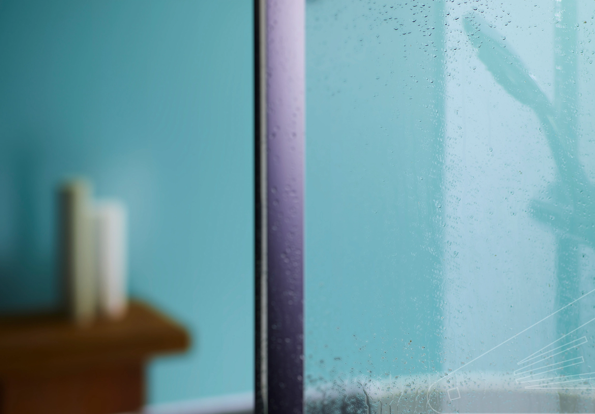 Mint Sation Cladding installed in a bathroom showing a still wet shower screen and reflection of shower head in the cladding.