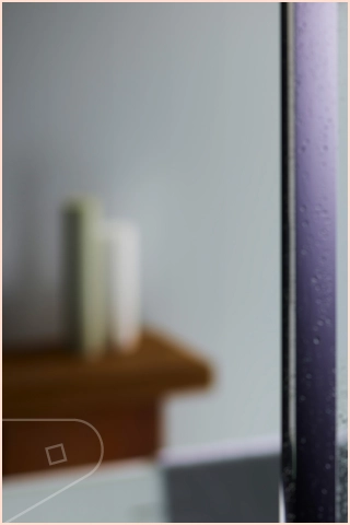 Clay Satin Cladding installed in a bathroom with ornamental candles and wet shower screen.