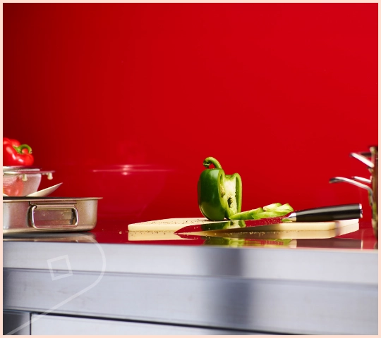 A close-up of featured colour Ruby Gloss cladding installed in a bathroom showing edge of shower screen.