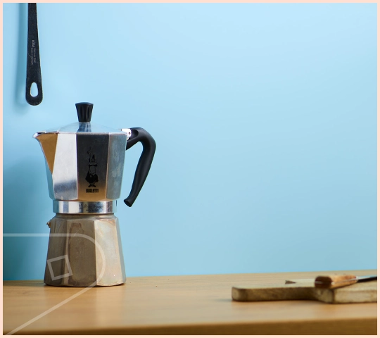 A close-up of featured colour Sky Satin cladding installed in a kitchen, showing wooden work surface and coffee percolator.