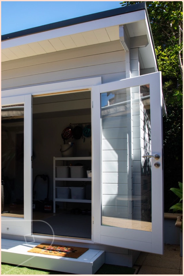 Image took from outside a summer house in the garden featuring Dove Satin wall cladding