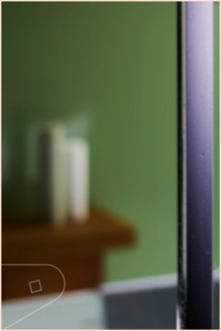 Stylish feature wall created using green Solid uPVC cladding panels in batroom