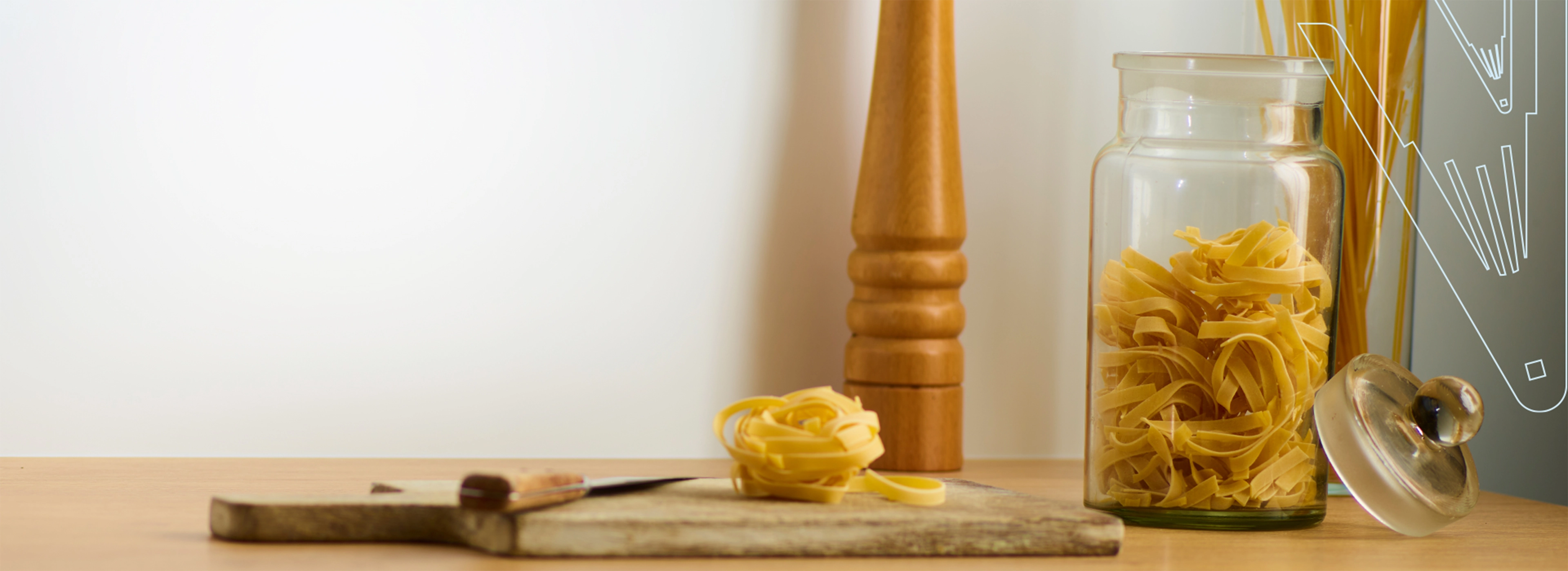 Direct Cladding in situ above kitchen worktop, with chopping board, pepper grinder and pasta.